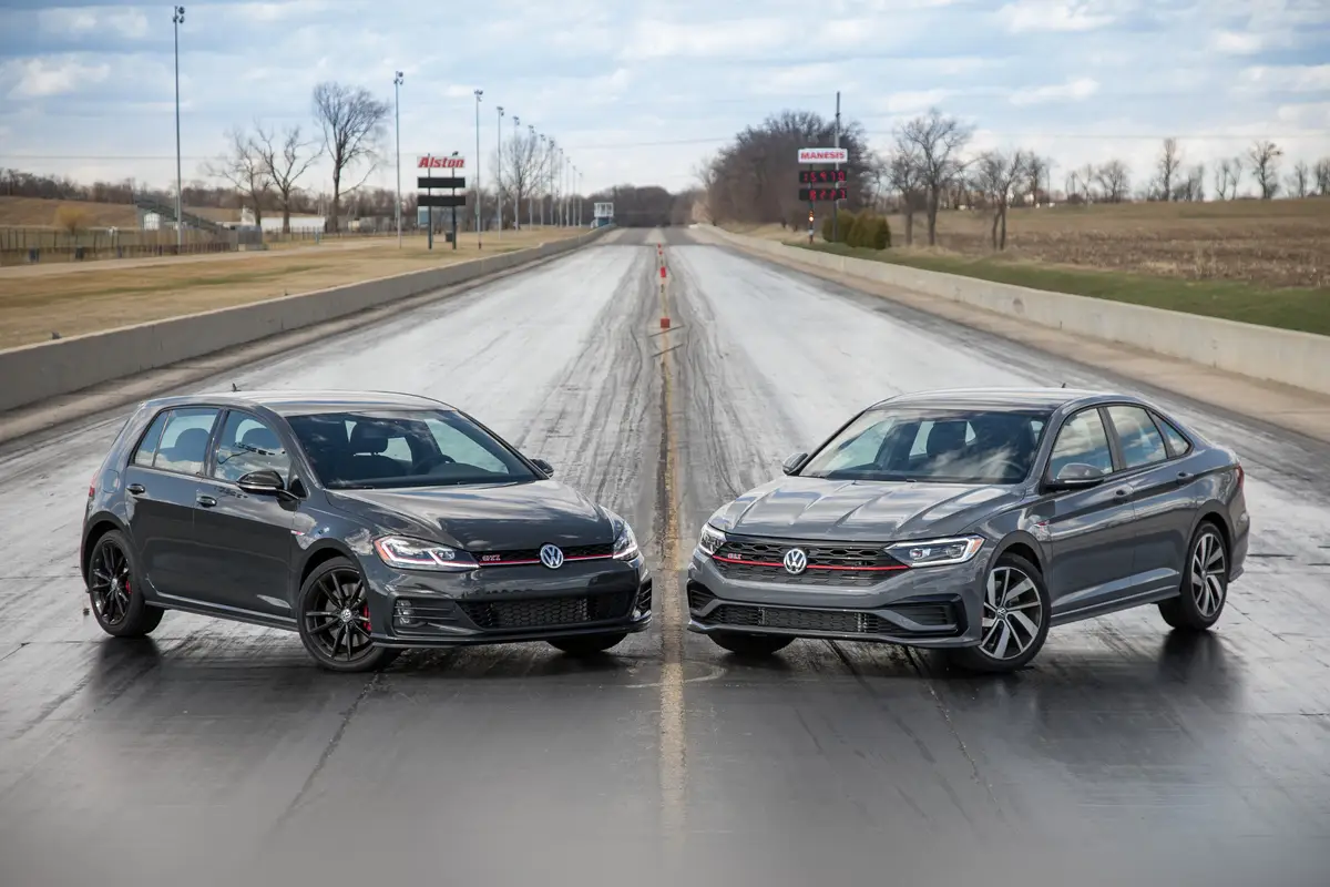 01-volkswagen-jetta-gli-and-golf-gti-2019-angle--drag-strip--exterior--front--grey--head-to-head.jpg