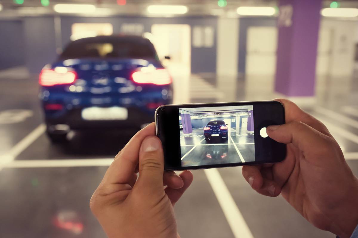 Car owner taking a photo of their car to sell.