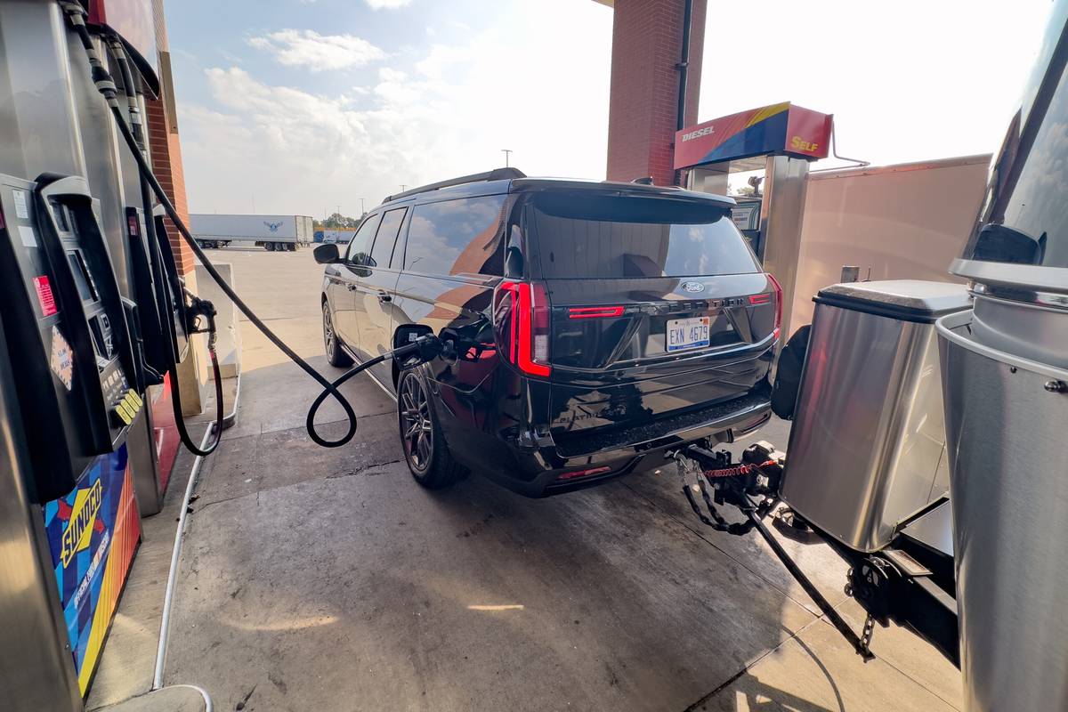 ford expedition max platinum 2025 04 exterior gas station rear angle scaled jpg