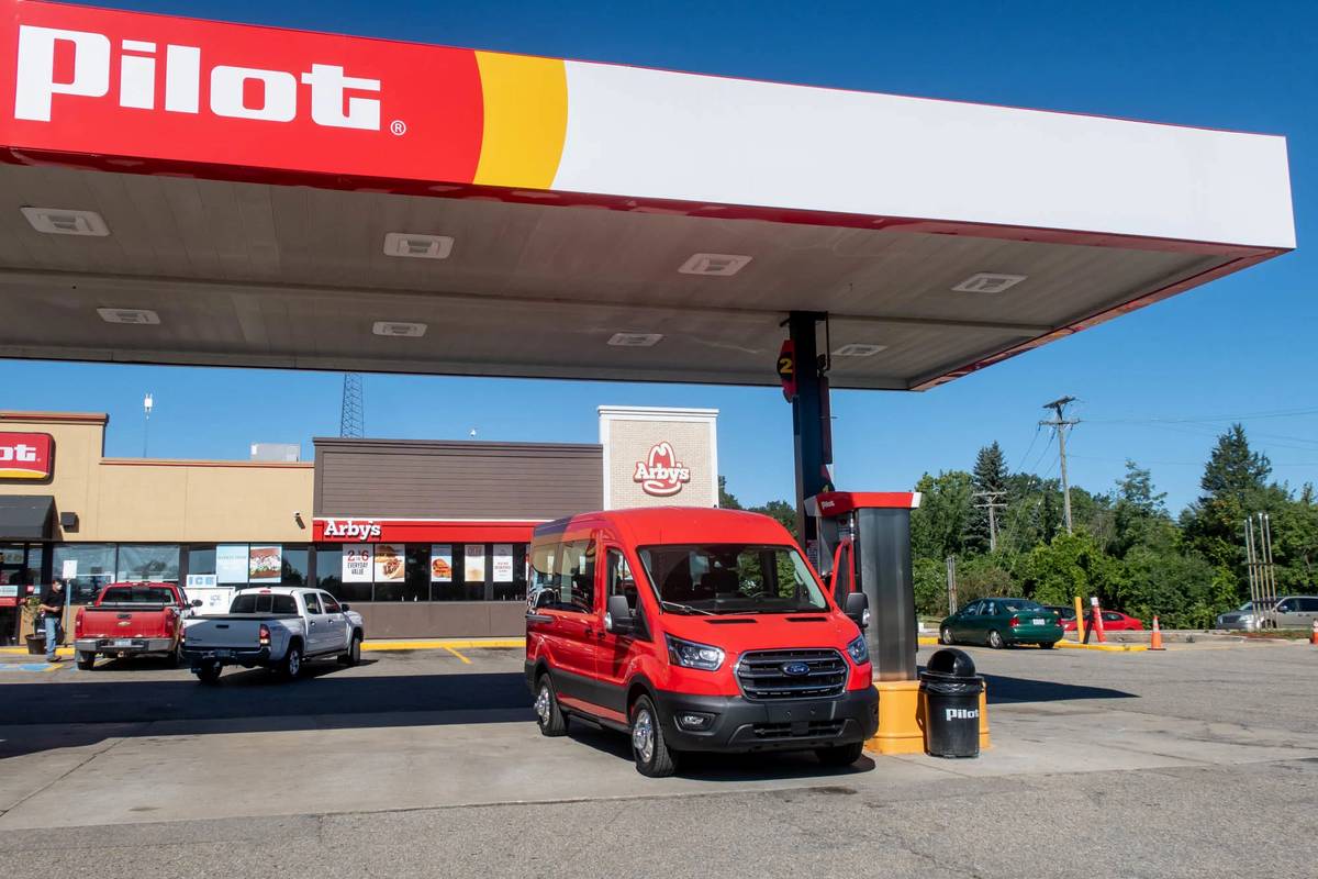 Red 2020 Ford Transit XL at a gas station