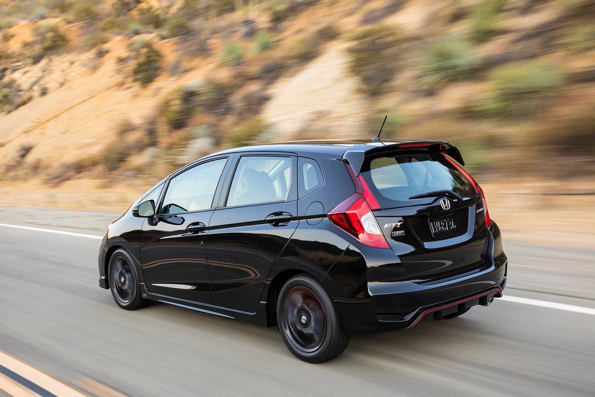 Black 2020 Honda Fit driving on a road