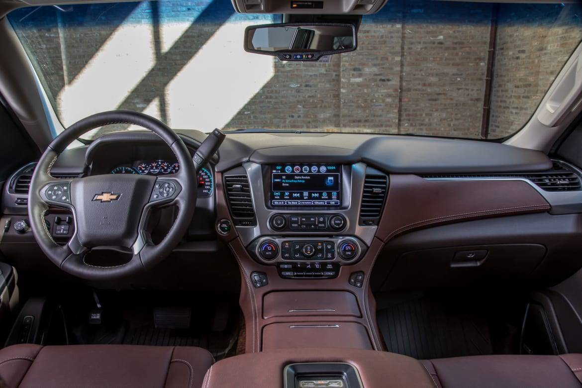 GM's full-size SUVs are among the few vehicles with a column-mounted gear selector, which lets Chevy offer a rare front bench seat. | Cars.com photo by Christian Lantry
