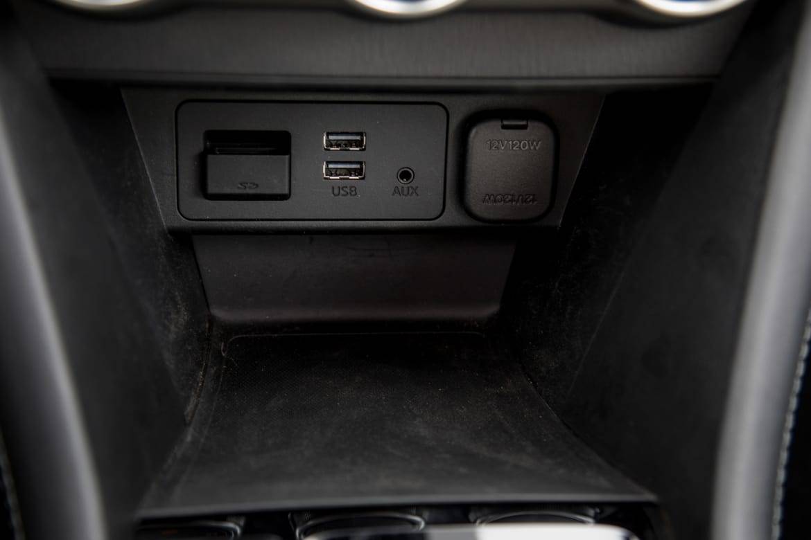 A front console device bin includes USB, auxiliary, 12-volt and SD media card ports. | Cars.com photo by Christian Lantry