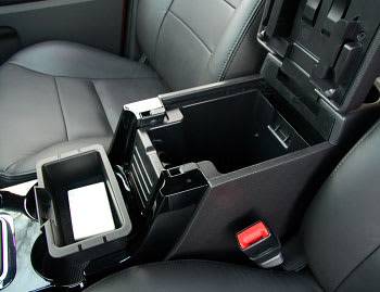 The tricked-out center storage console now has a small tray (removed, above) &#x2014; and a huge bin that you can hang off to the side (below). Why? Hell if we know. It gives you a place to put it when accessing the bottom of the bin, at least. | 