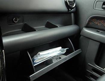 The glove compartment is average-size, but it&#39;s just one of many places to stash things. A three-tier shelf sits above it, and the front doors (below) have big pockets and heavy-duty armrests coated with a durable, rubber-like material. | 