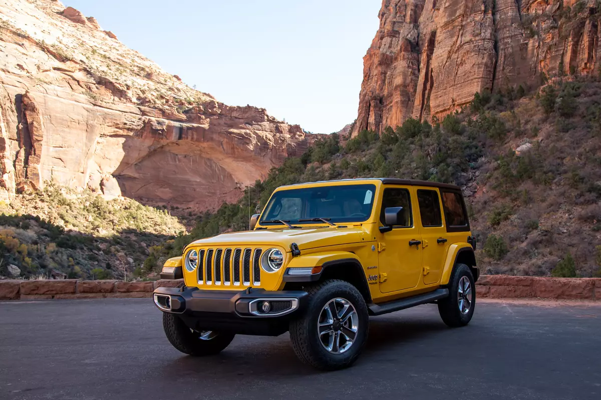 A yellow 2020 Jeep Wrangler Unlimited EcoDiesel in front of mountains