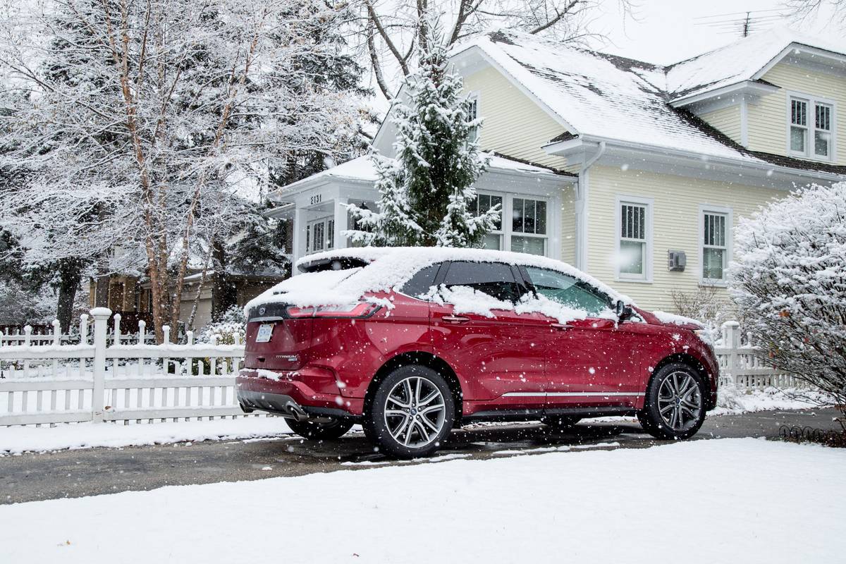 Red 2019 Ford Edge covered in snow