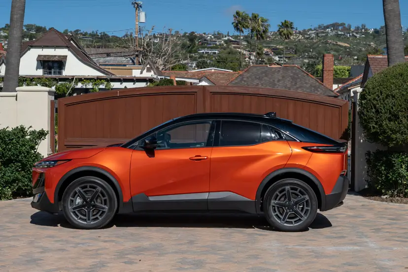 A 2026 Subaru Uncharted GT in Habanero Two Tone paint driving through a city commute.
