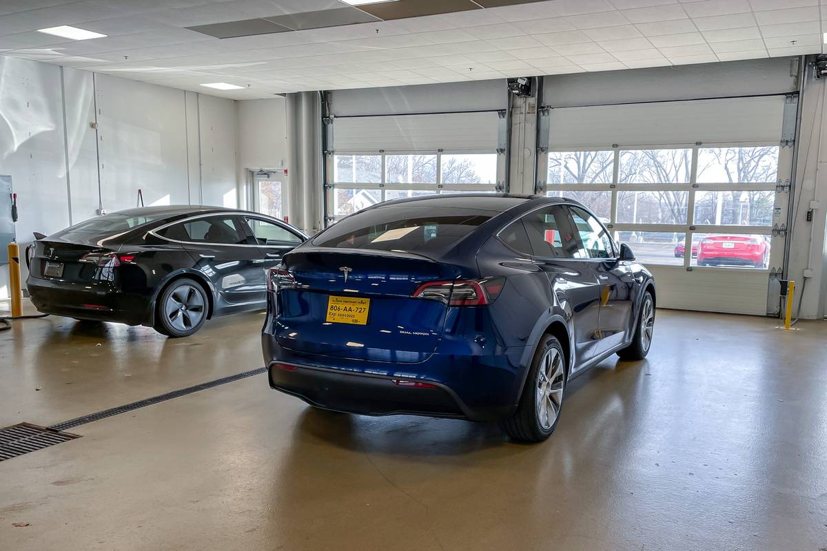 https://images.cars.com/cldstatic/wp-content/uploads/tesla-model-y-2021-15-blue-detail-exterior-rear-angle-sedan-scaled.jpg